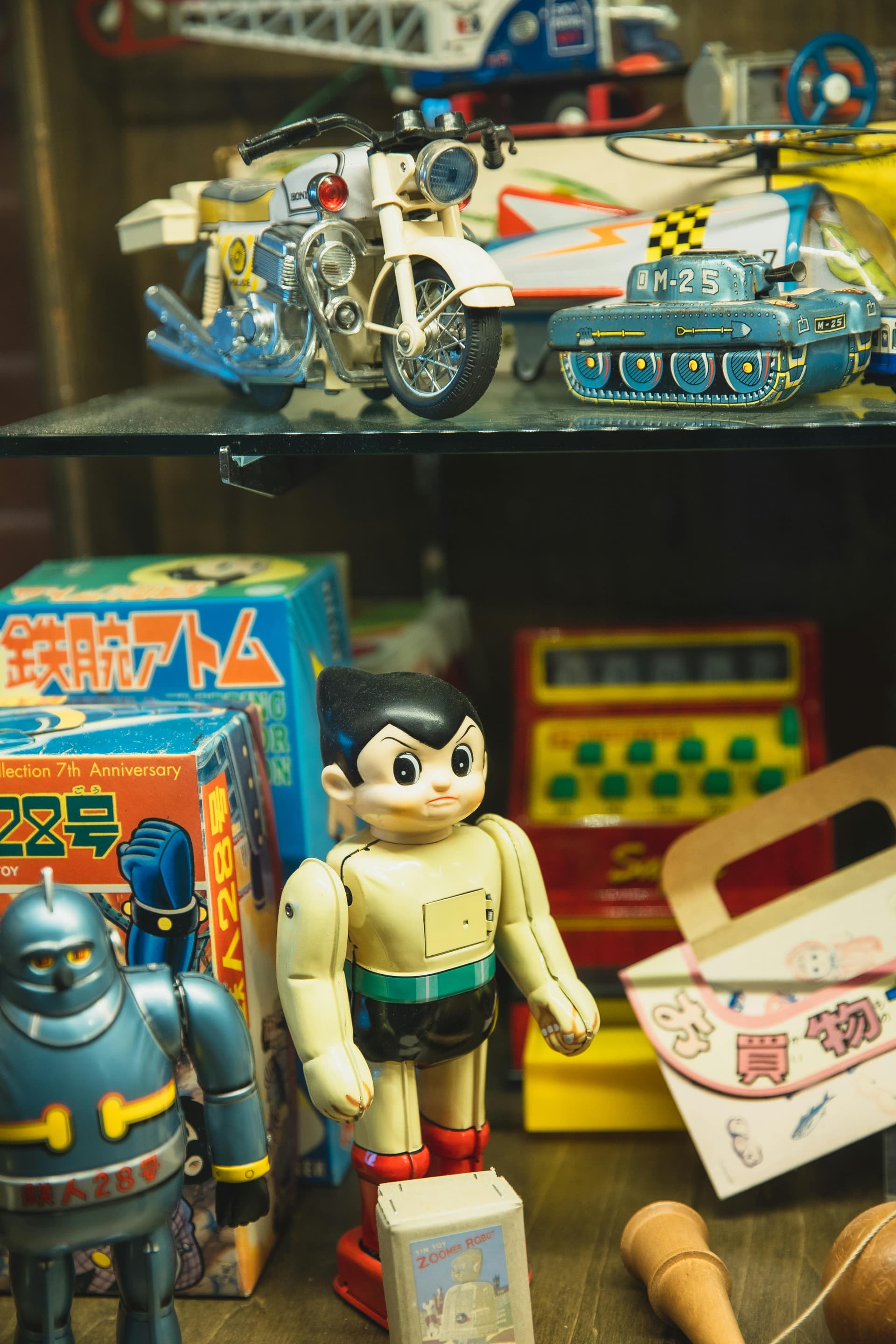 Rare vintage anime collectibles displayed in glass cases at a specialist shop