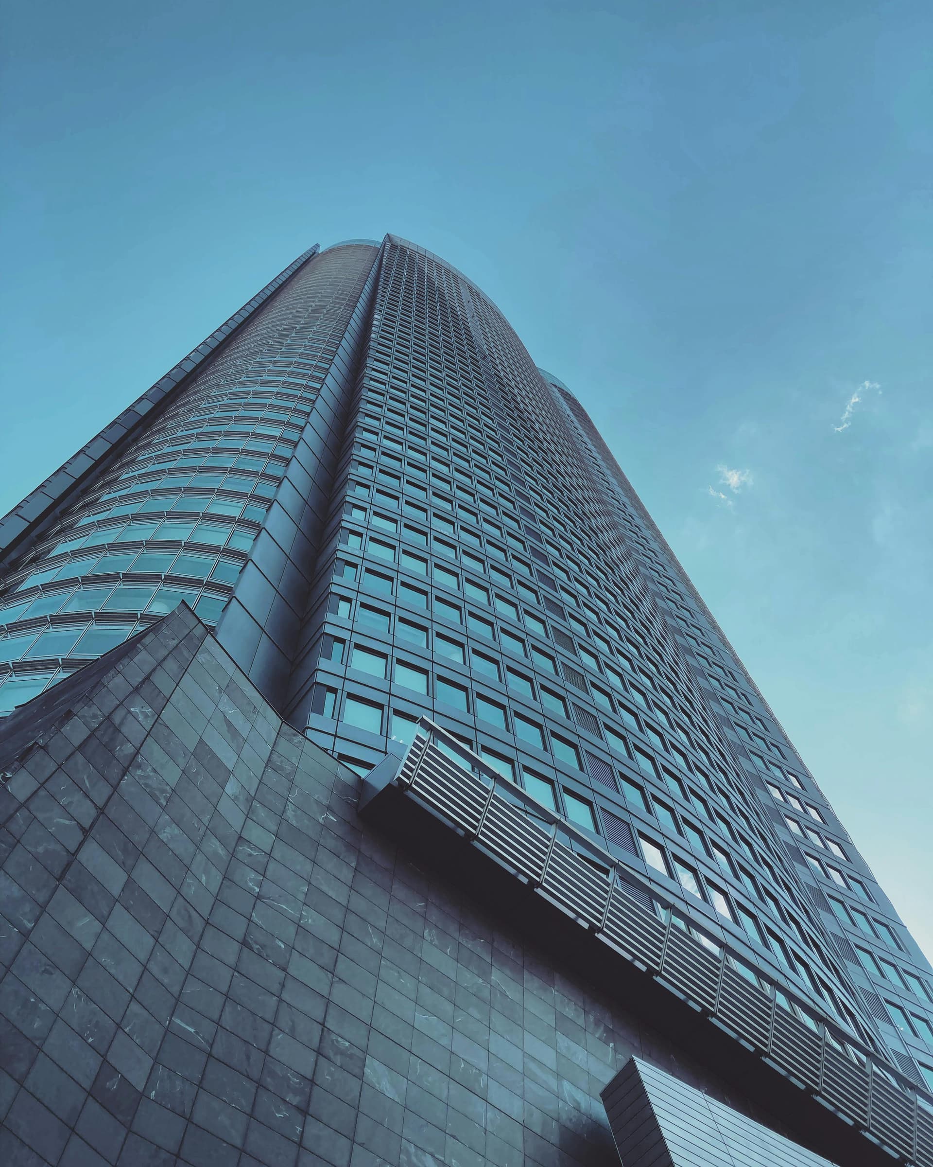 Roppongi Hills Mori Tower facade seen from below showing curved steel and glass geometry