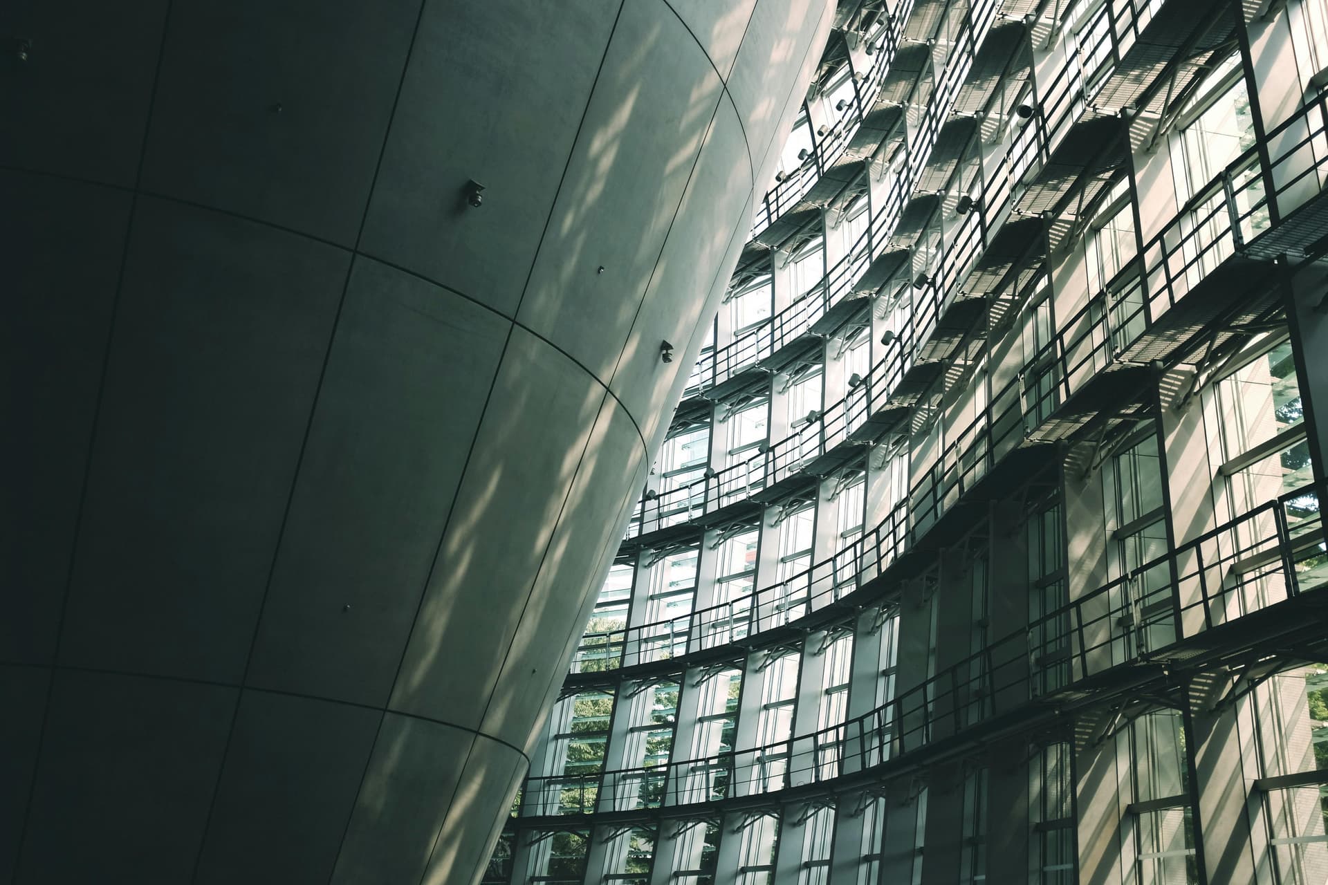Undulating glass curtain wall interior of the National Art Center Tokyo by Kisho Kurokawa