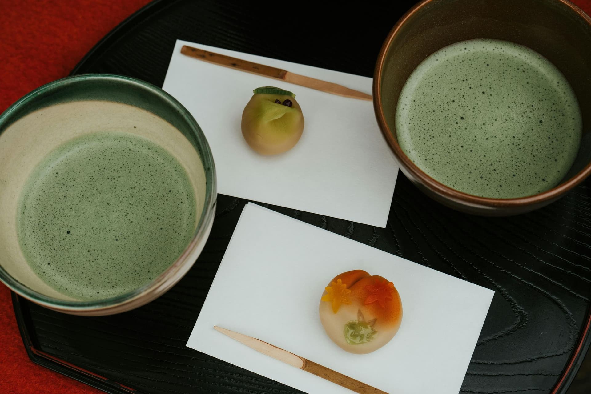 Matcha tea ceremony with seasonal wagashi sweets on lacquer tray