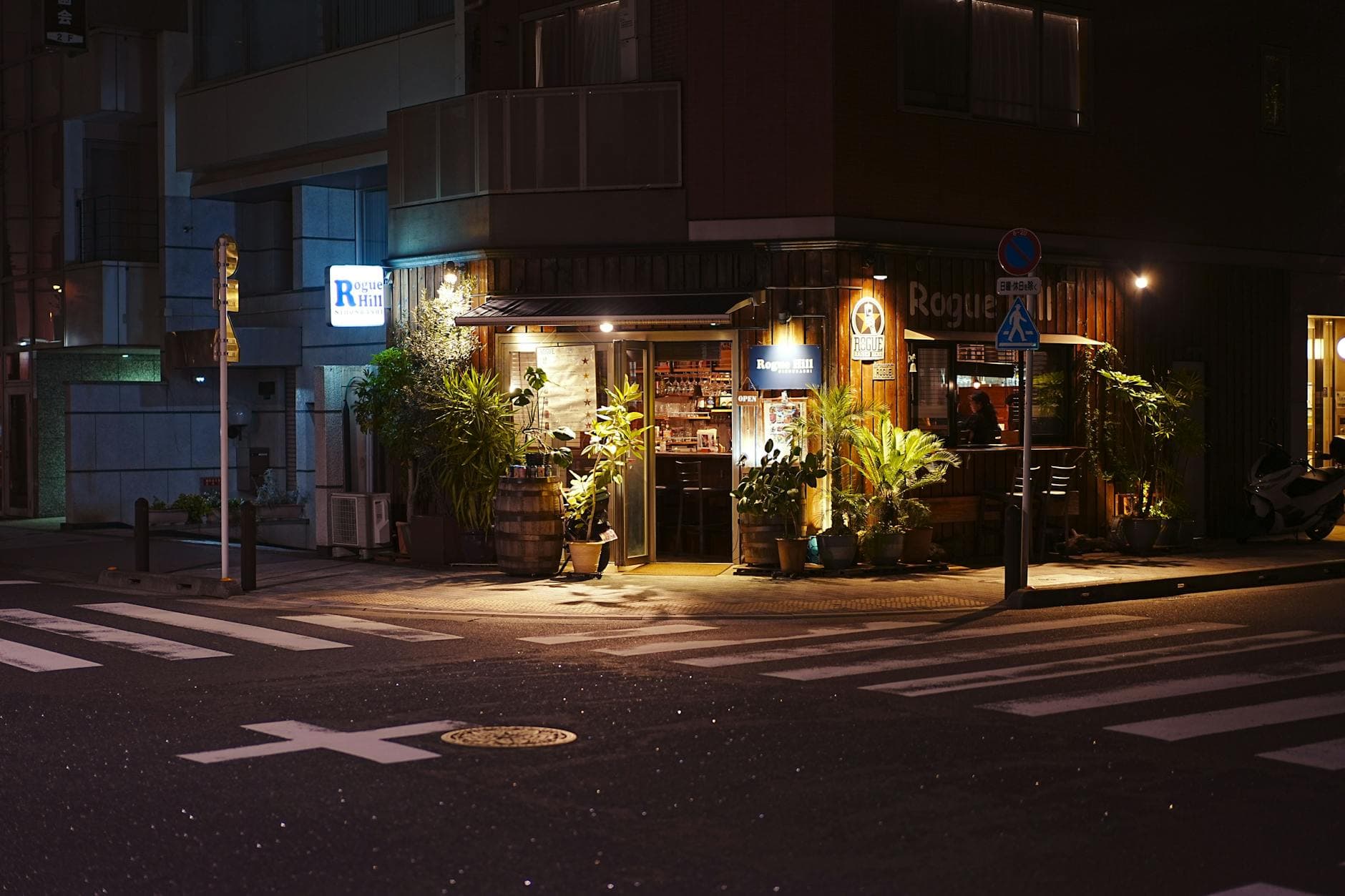 Charming cafe illuminated at night on a quiet Tokyo side street