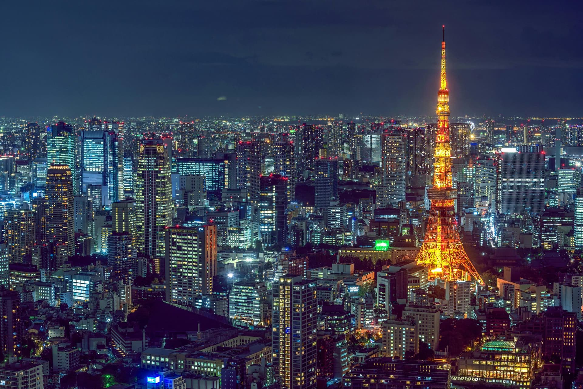 Tokyo Tower glowing against the city skyline at night