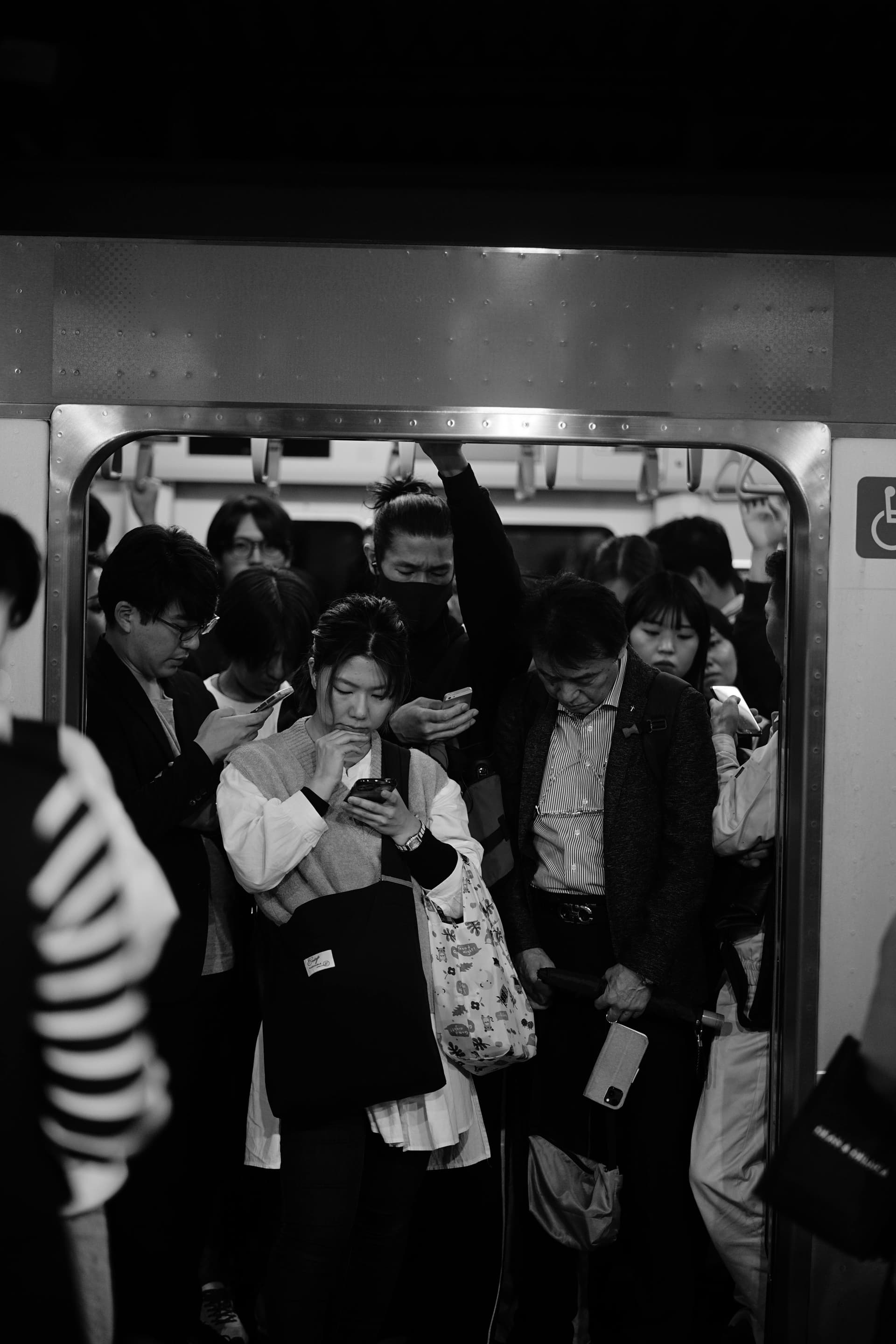 Packed rush hour train in Tokyo with commuters pressed against doors