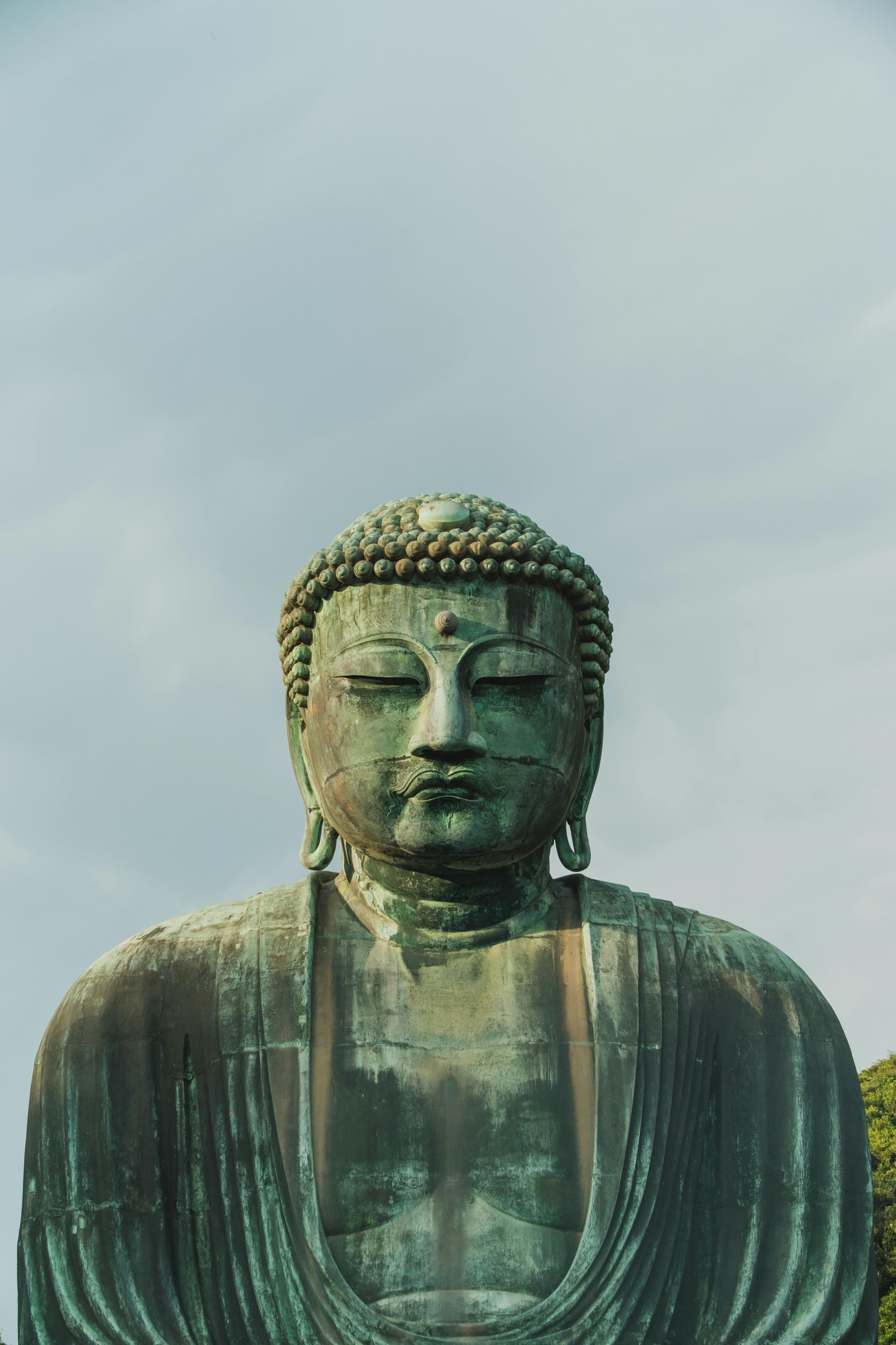 Great Buddha of Kamakura bronze statue against open sky