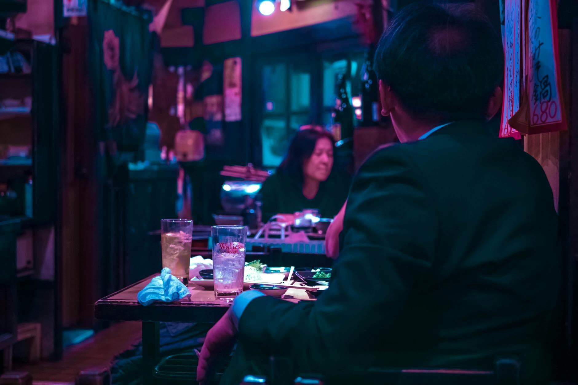 Vibrant Tokyo izakaya interior with wooden counter and evening atmosphere