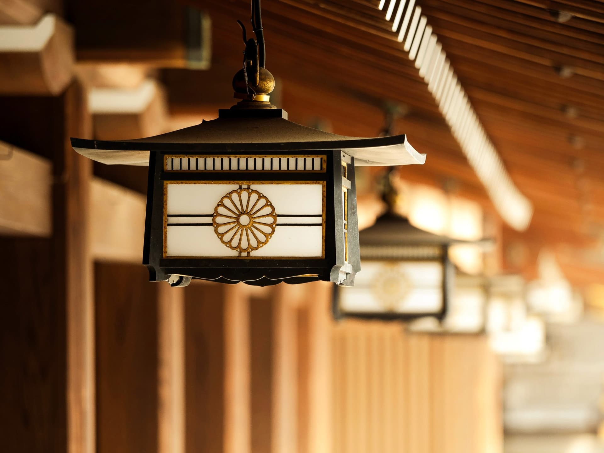 Peaceful Togo Shrine grounds with traditional lanterns hidden behind Takeshita Street