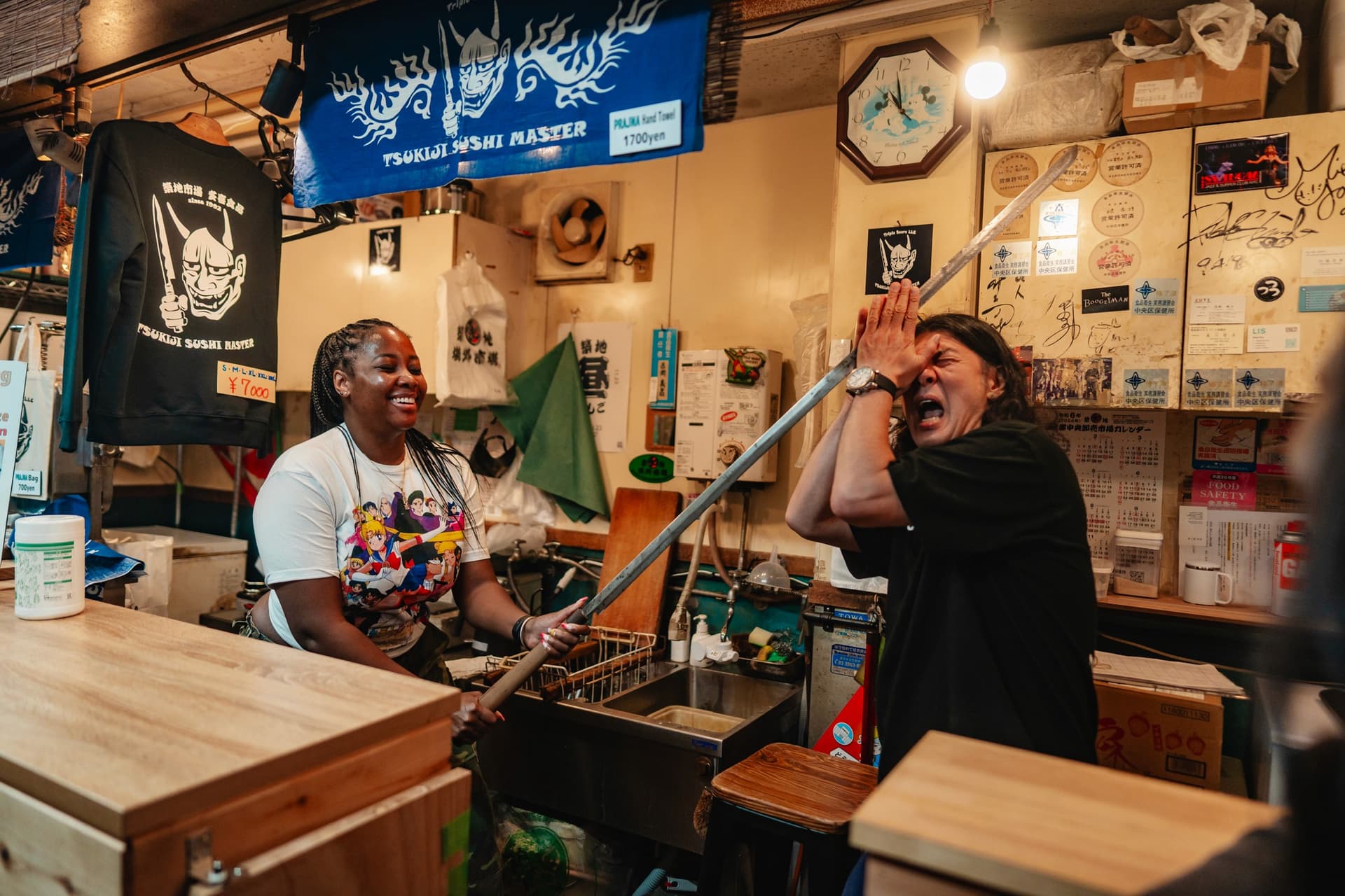 Customers at a narrow standing bar counter with handwritten menu boards