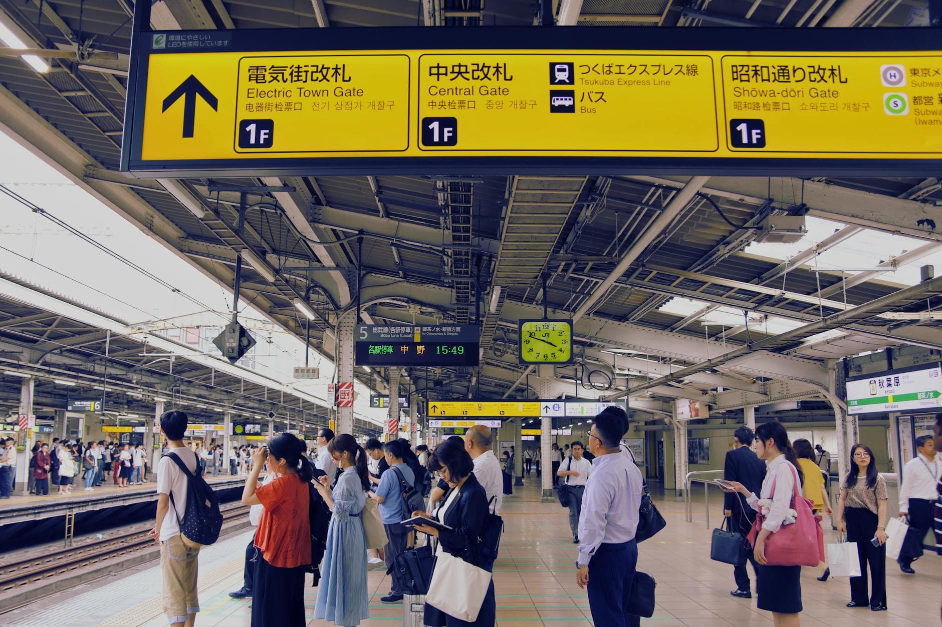 Commuters waiting on a busy Tokyo train station platform