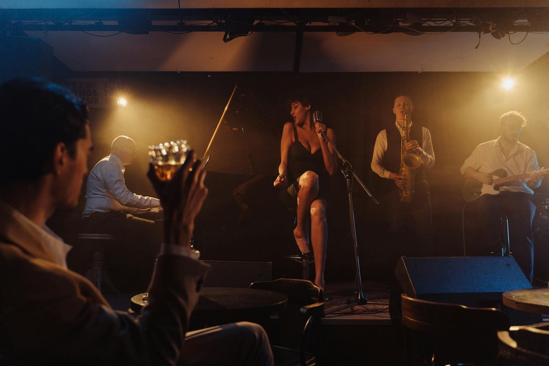 Live jazz band performing on stage in a cozy dimly lit bar
