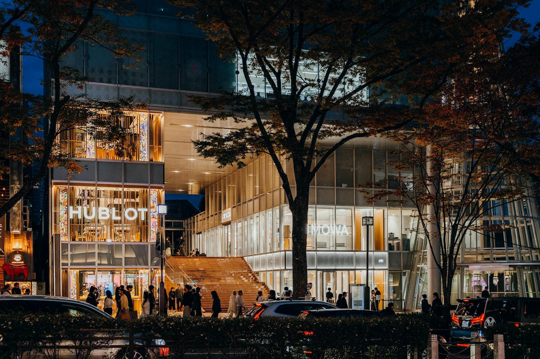 Modern luxury retail complex with architectural lighting at night
