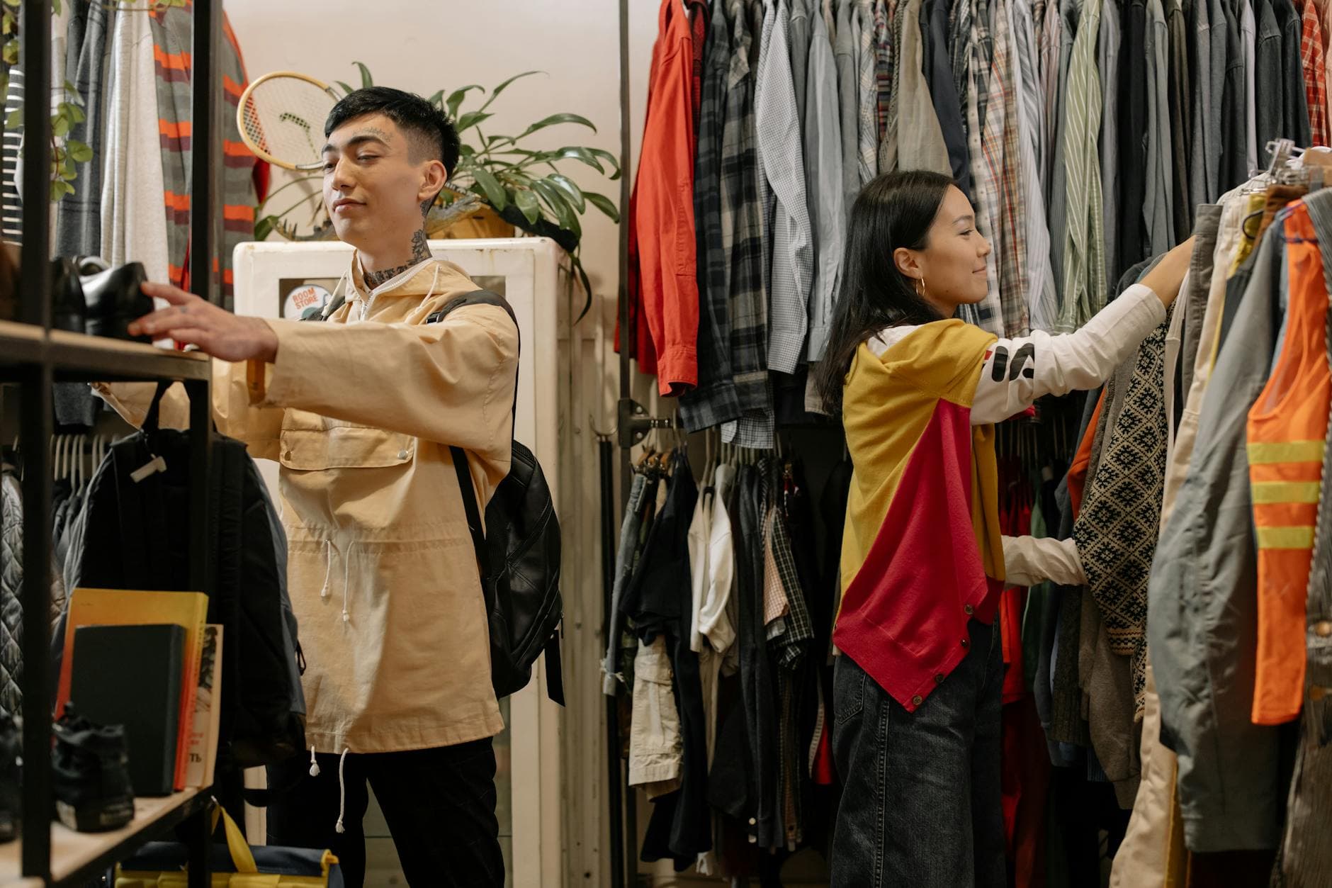 Shoppers browsing vintage clothing racks inside thrift store