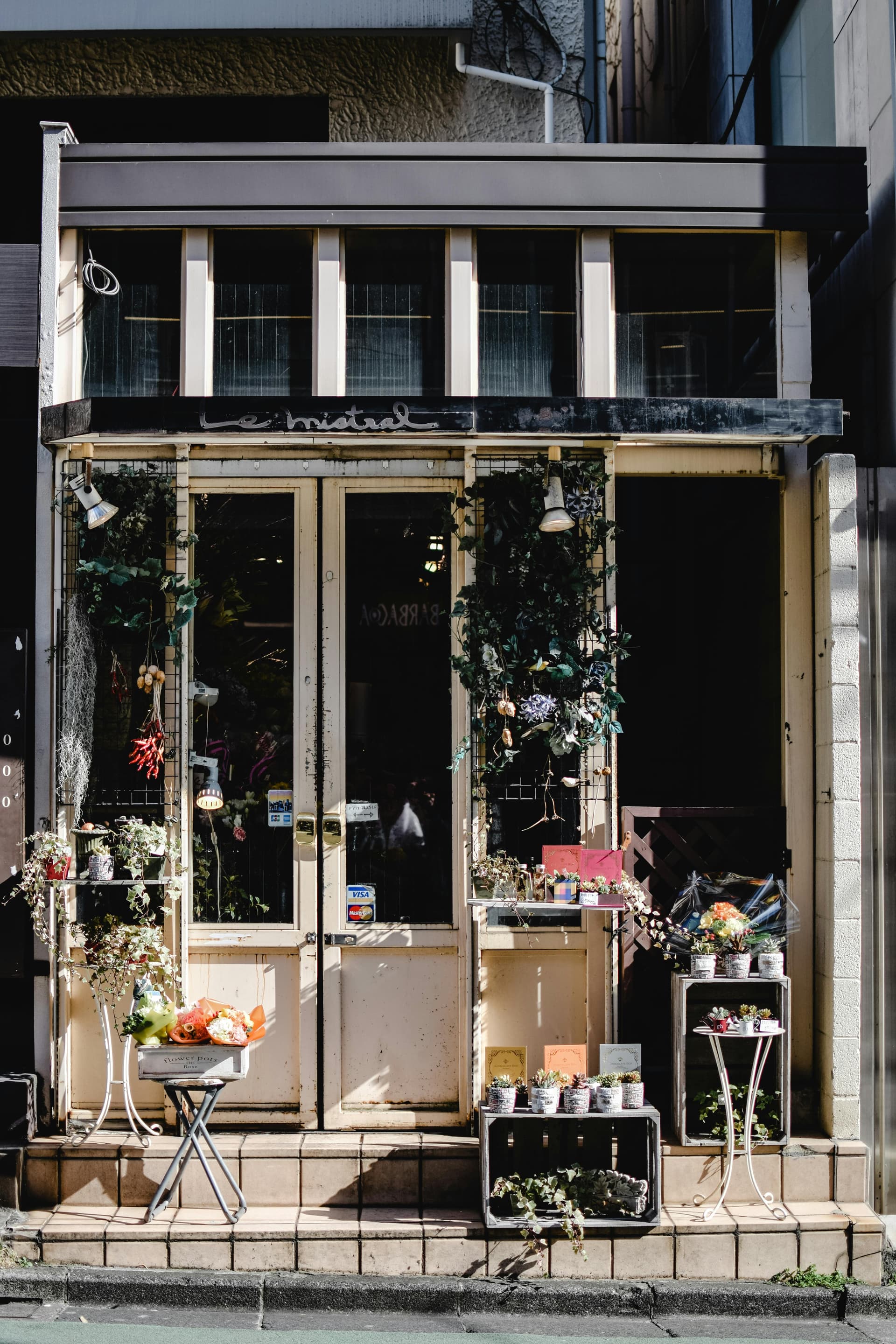 Charming flower shop facade with potted arrangements spilling onto a quiet sidewalk