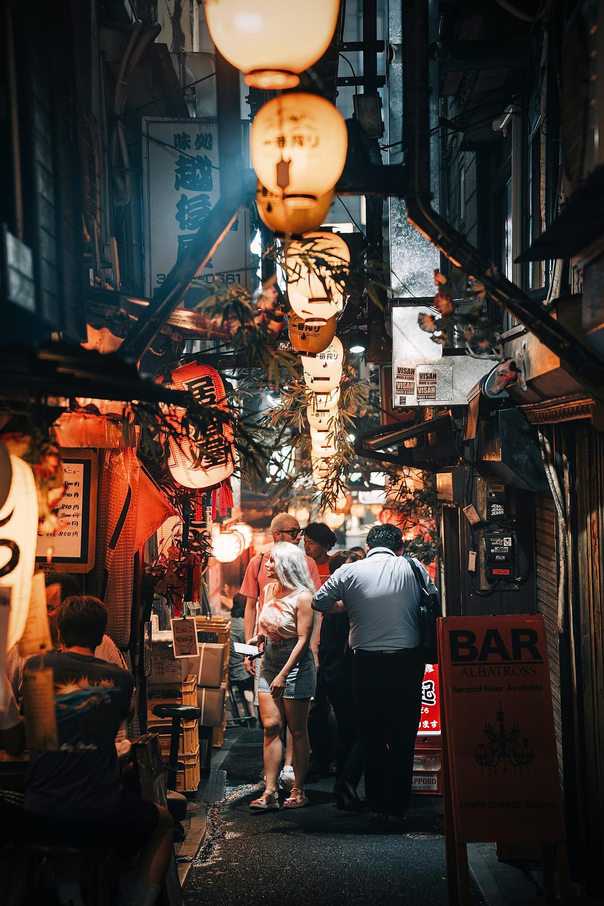 Narrow izakaya alley crammed with glowing lanterns and bar signs
