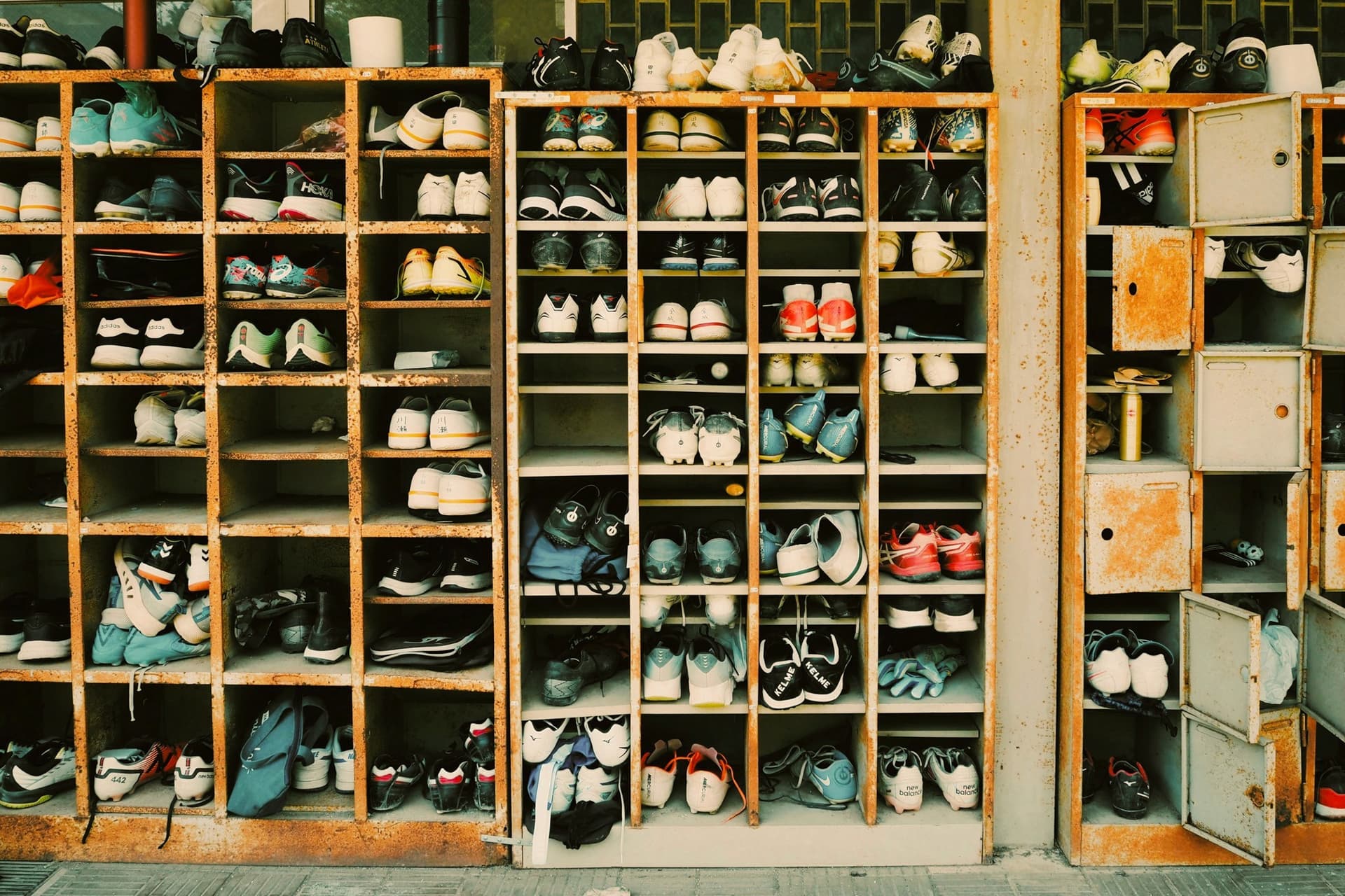 Wooden cubbies packed with worn bowling shoes in a local alley bowling hall