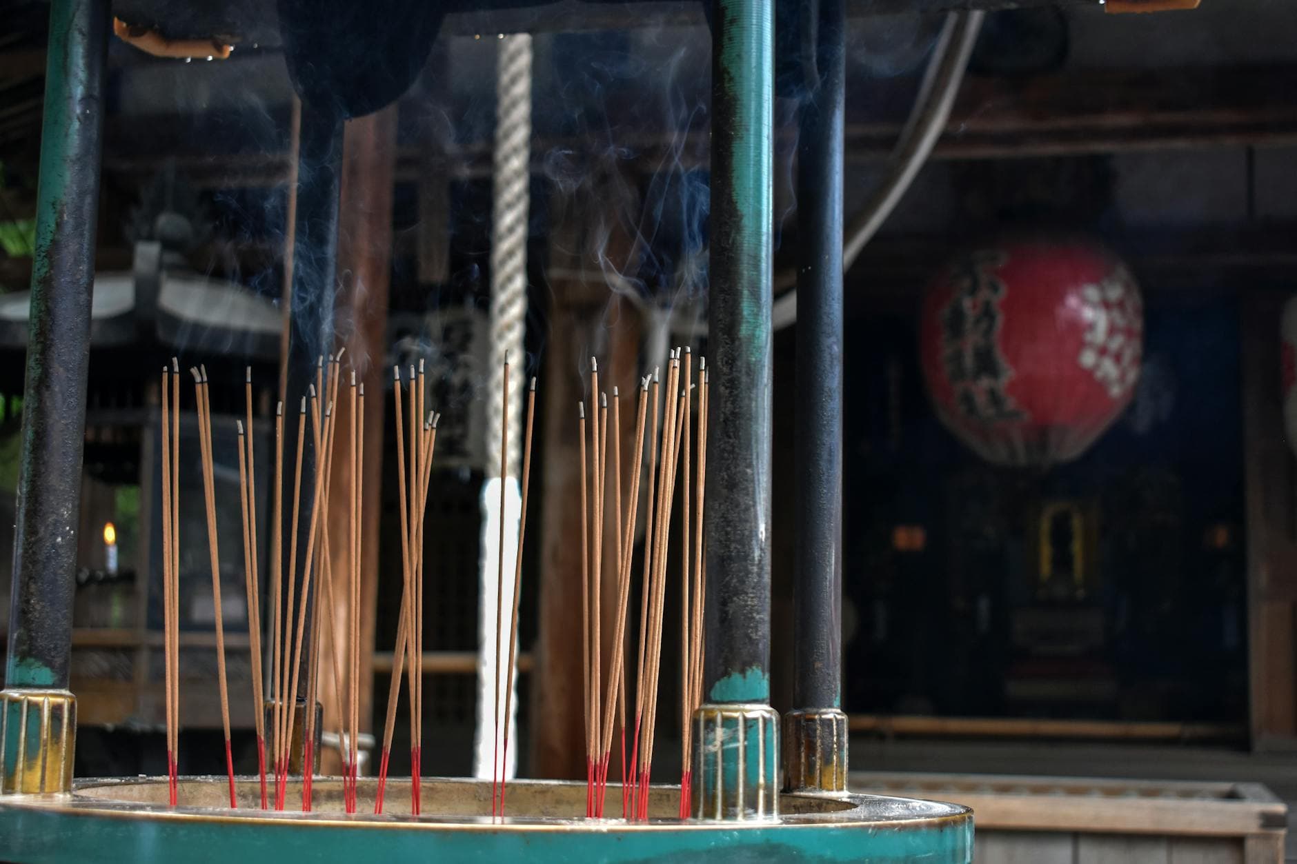 Incense sticks burning in an urn at a Tokyo shrine with smoke rising in the air