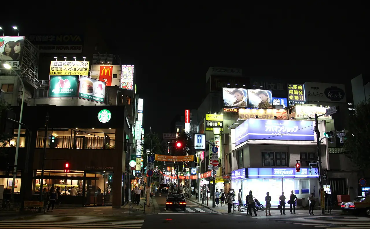 Shops and restaurants along Kagurazaka-dori lit up on a summer evening