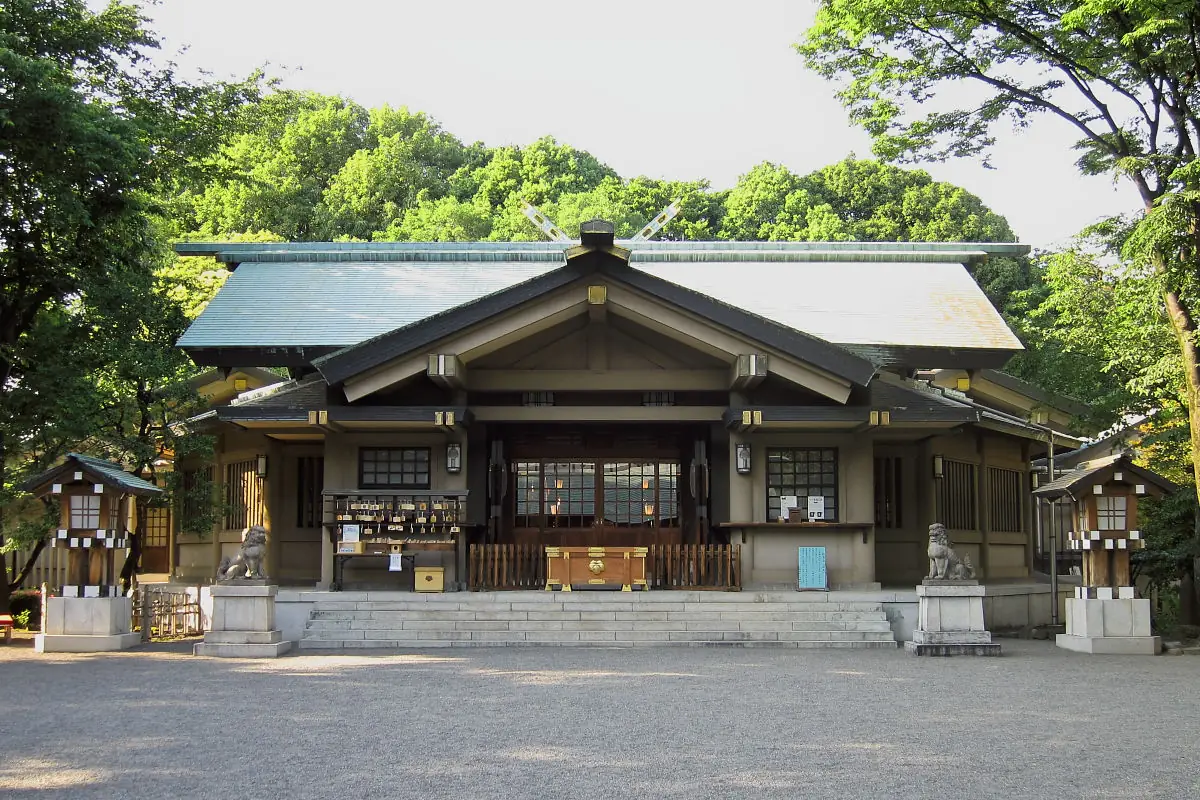 Main hall of Togo Shrine in Harajuku behind stone lanterns
