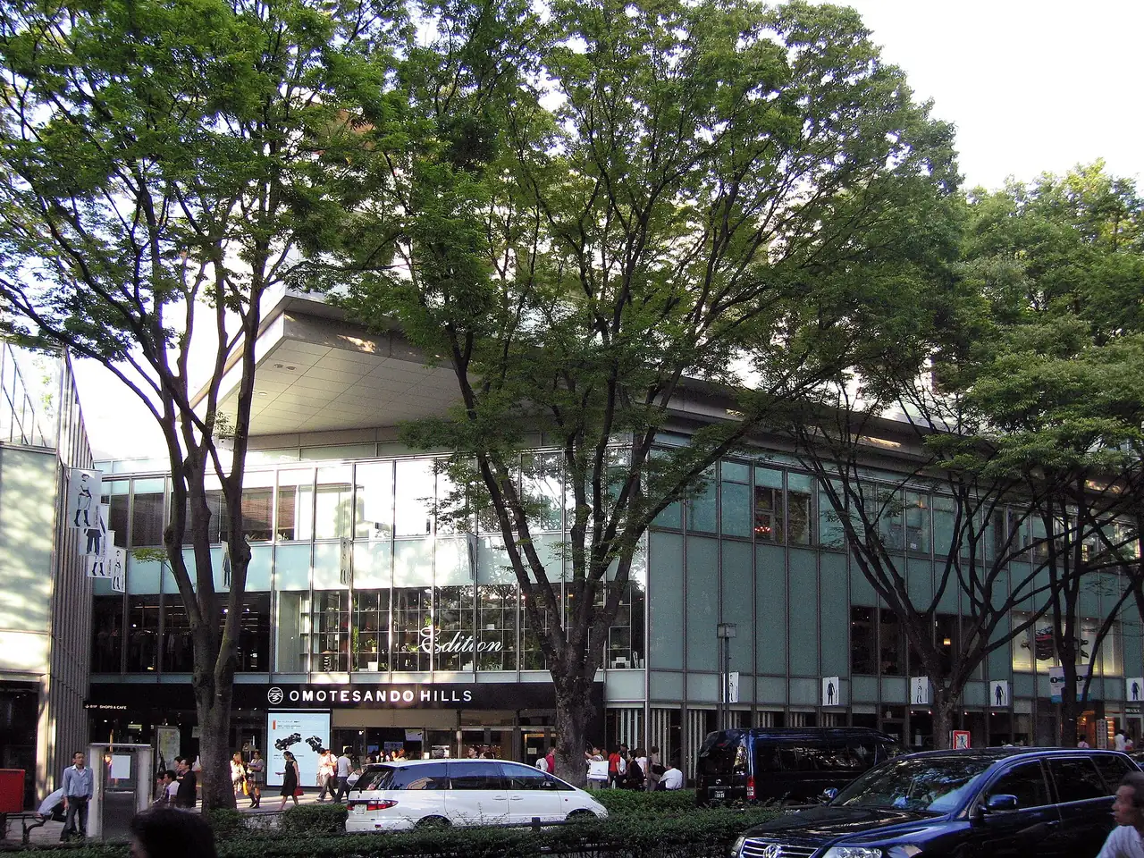 Low glass frontage of Omotesando Hills behind the zelkova trees on Omotesando