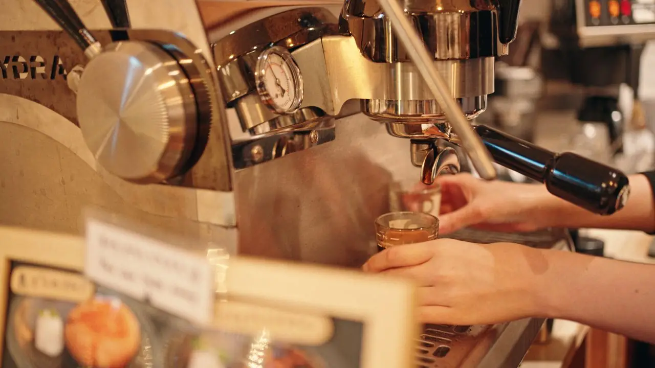 Barista pulling an espresso shot at a small independent coffee bar in Tokyo