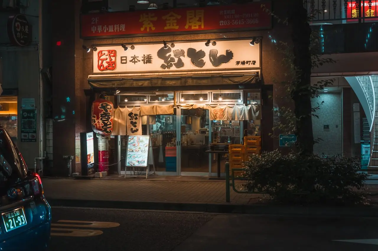 Lit storefront of a neighborhood restaurant in Nihonbashi, Tokyo, at night