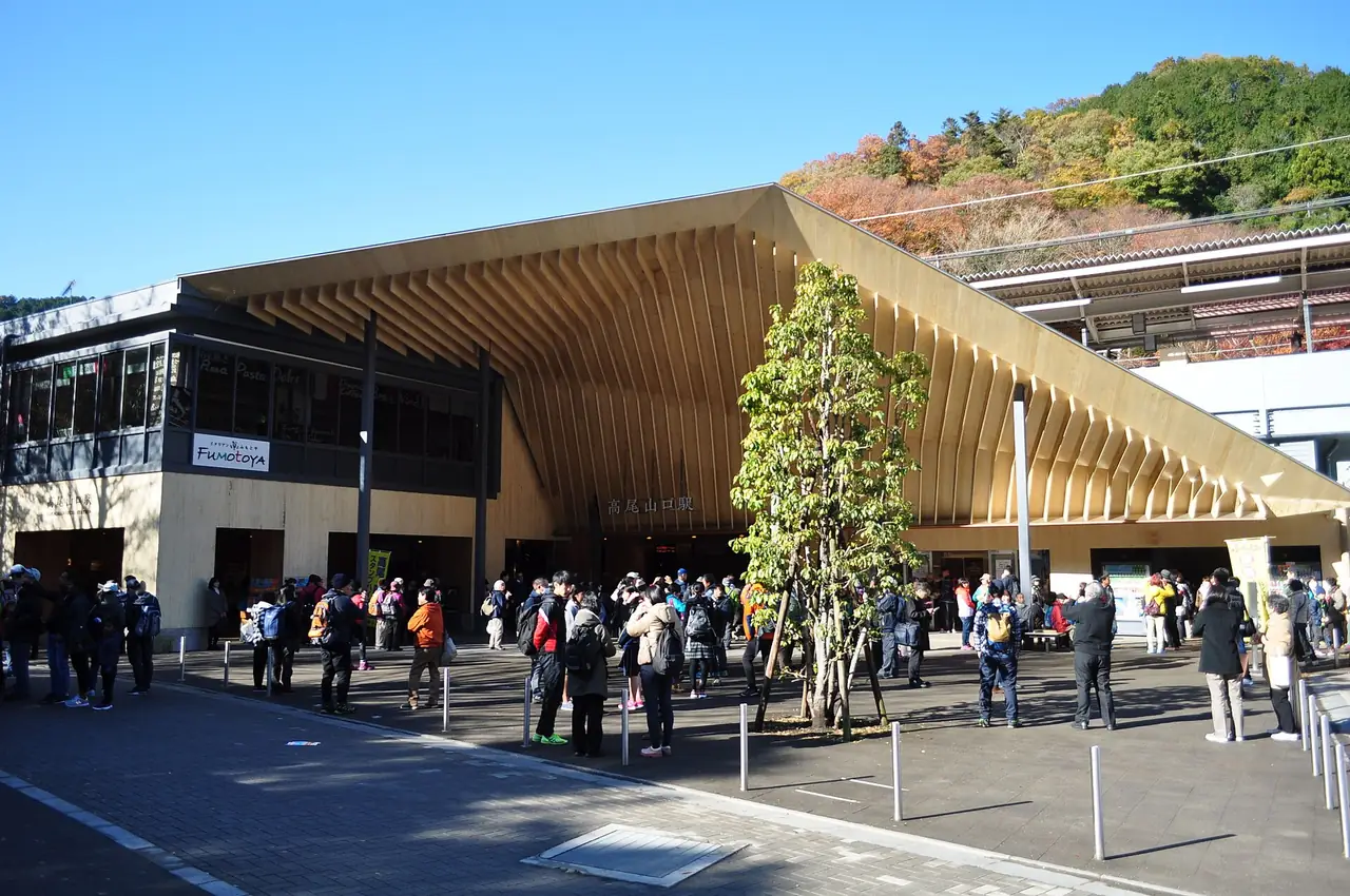 Crowds of hikers on the plaza outside Takaosanguchi Station in autumn