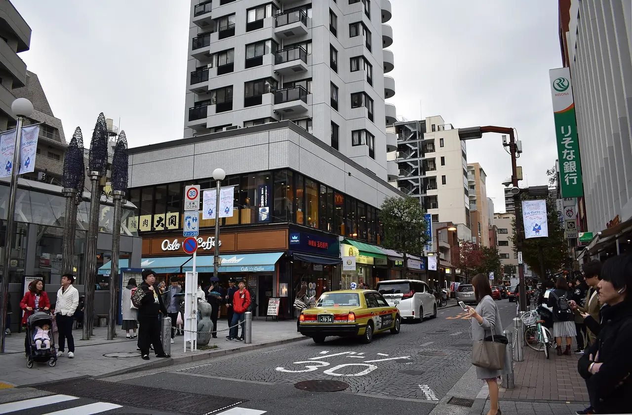 Shops at a corner of the Azabu-Juban shopping street below apartment towers