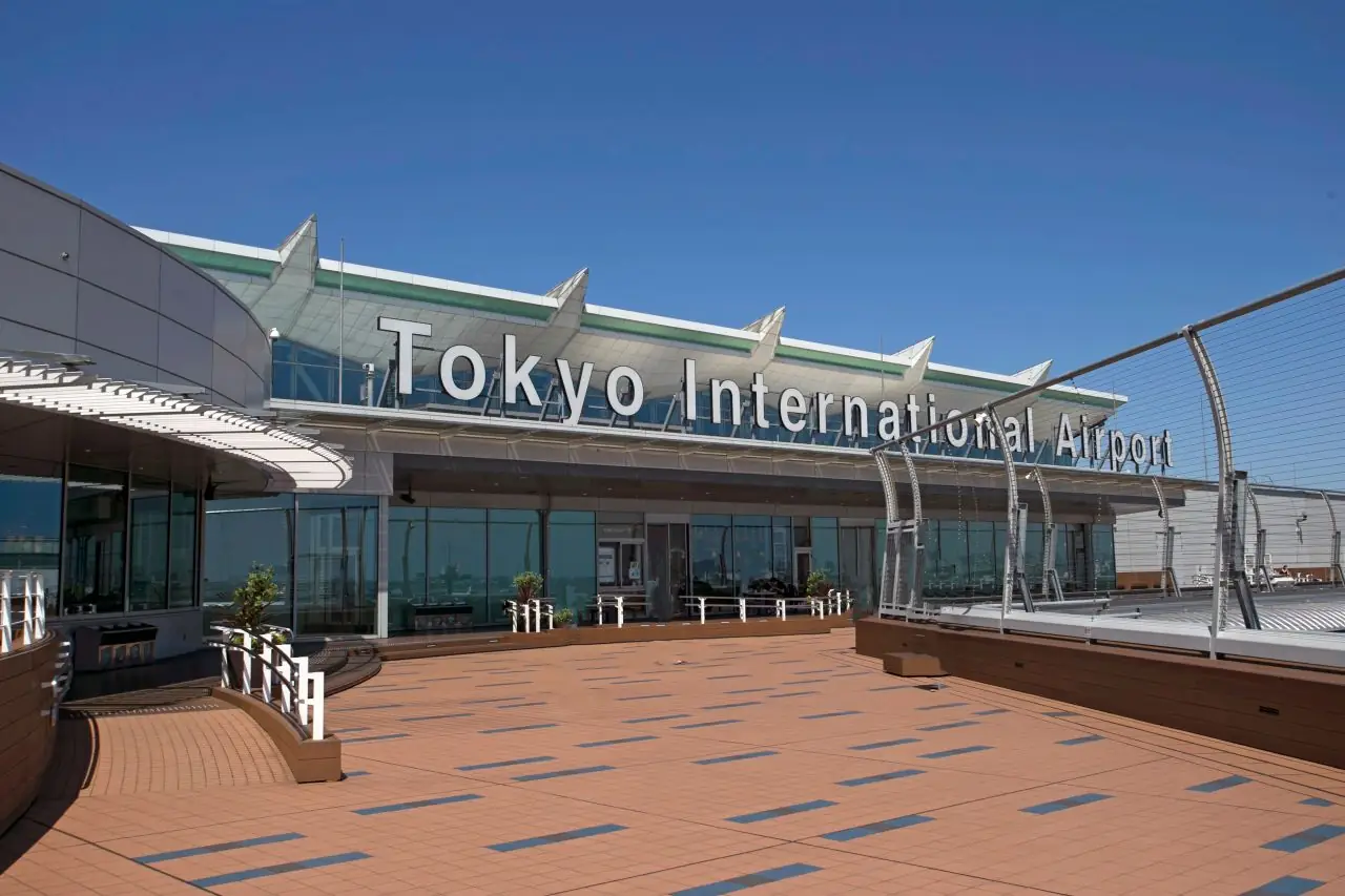 Rooftop observation deck at Haneda Airport under the Tokyo International Airport sign