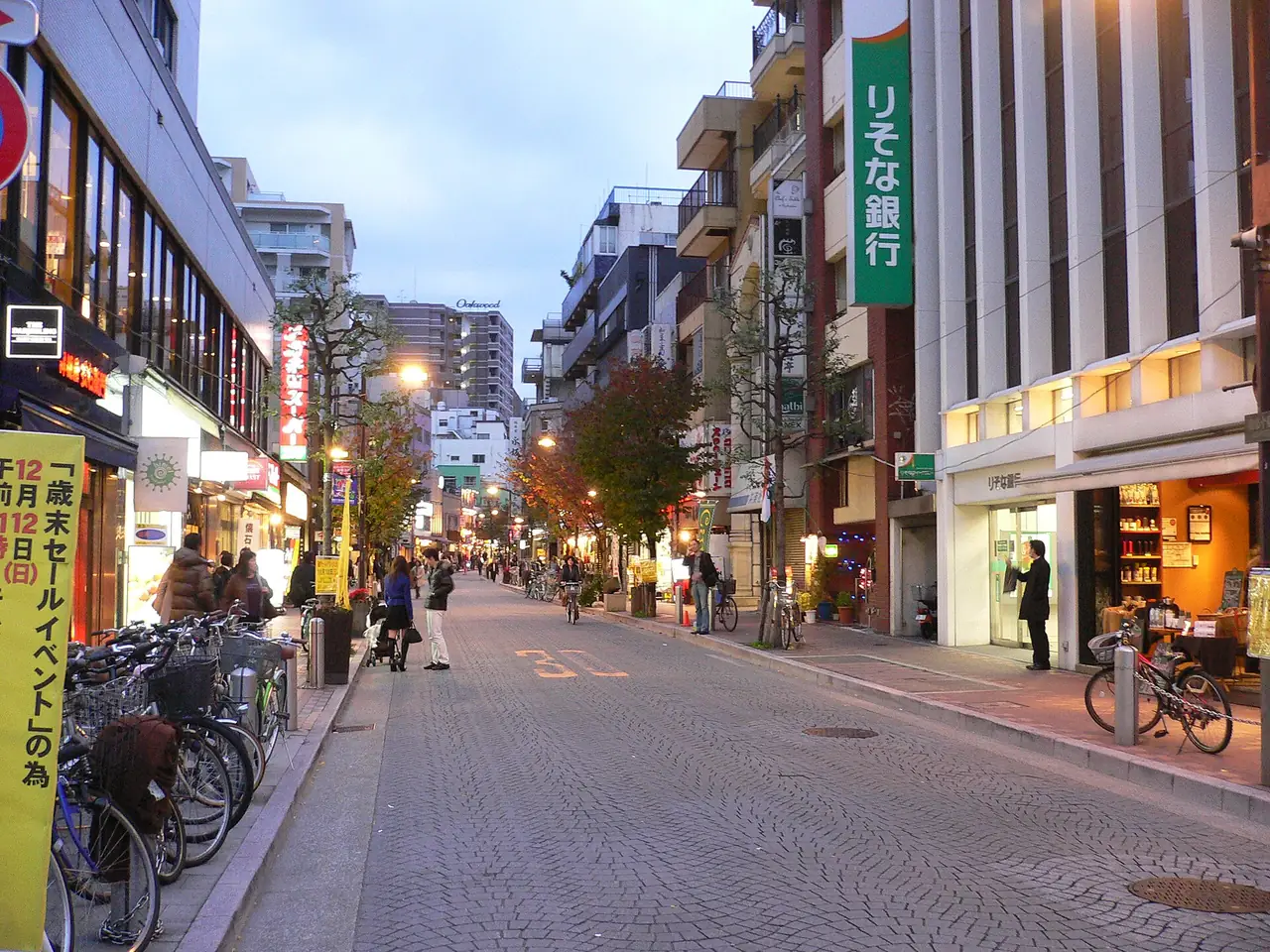 Azabu-Juban shopping street at dusk with bicycles parked outside the shops