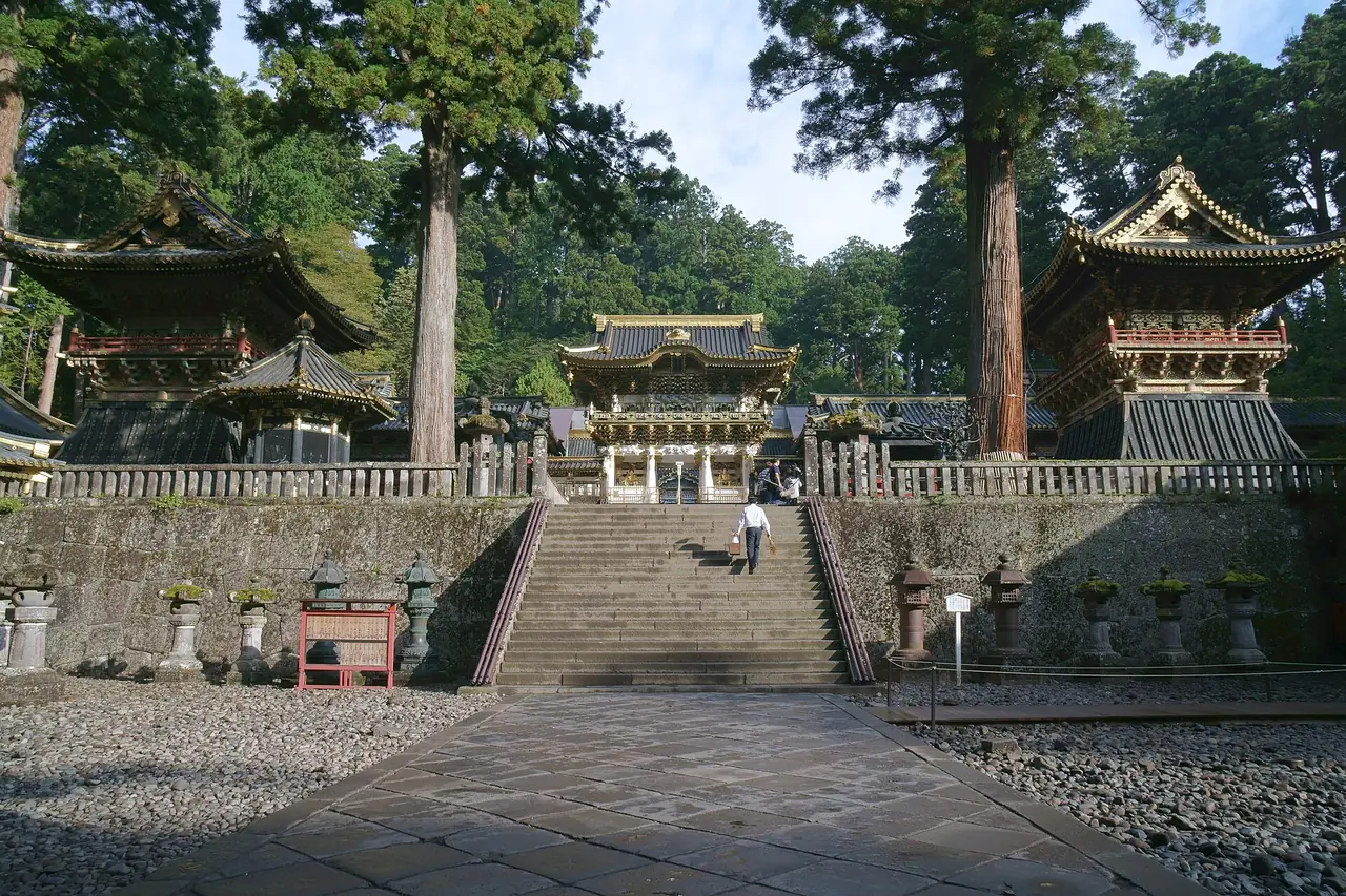Stone steps up to Yomeimon gate between cedars at Nikko Toshogu Shrine