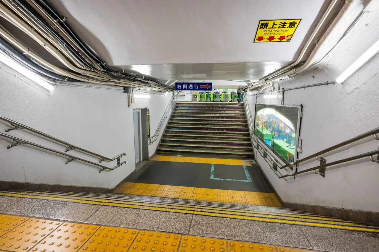 Stairs climbing to the ticket gates from an underground station passage in Japan