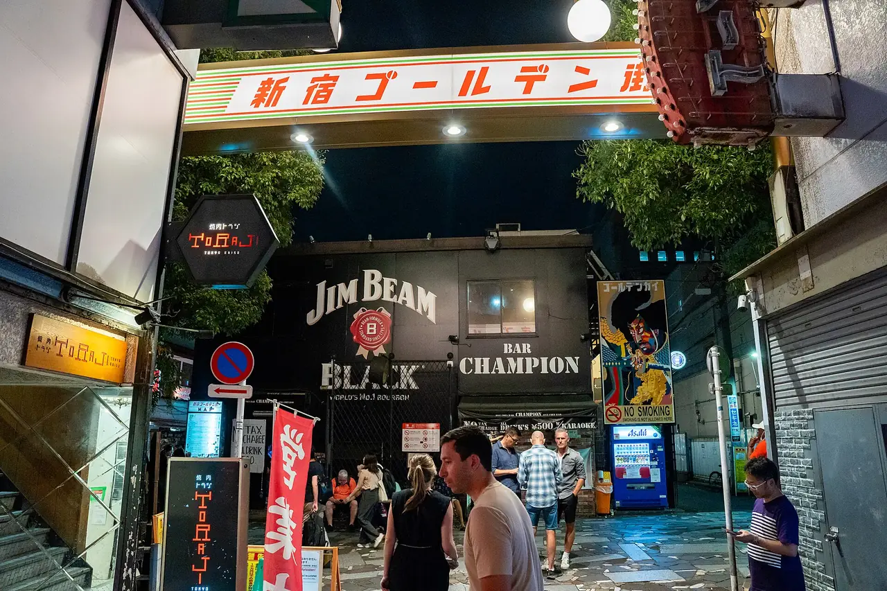 Lit Shinjuku Golden Gai sign over an alley entrance at night