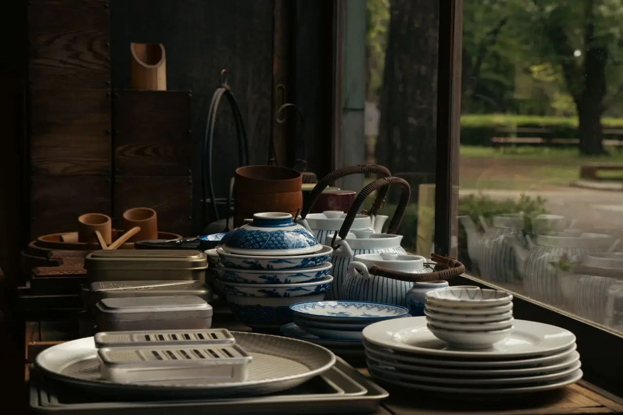 Blue and white Japanese ceramics stacked by the window of an old wooden shop