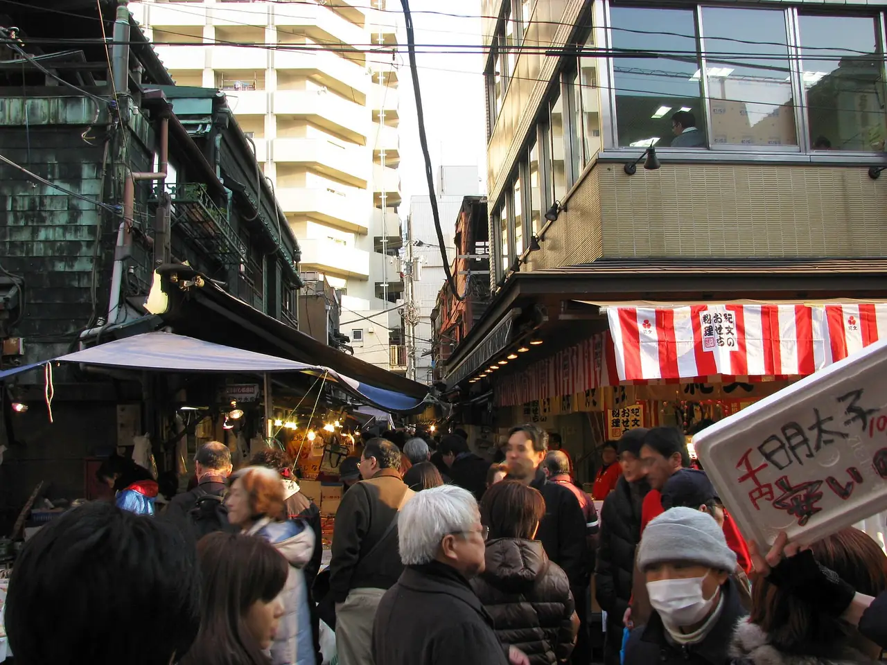 Shoppers crowding a narrow lane of the Tsukiji Outer Market