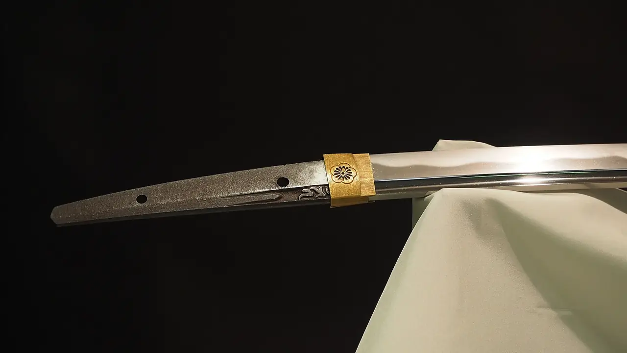 Tang, gold collar and polished blade of an Edo-period katana on display