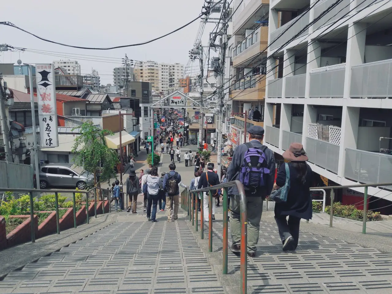 Visitors walking down the Yuyake Dandan steps toward Yanaka Ginza