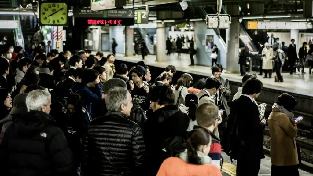 Passengers crowding a Yamanote Line platform in Tokyo as a train approaches