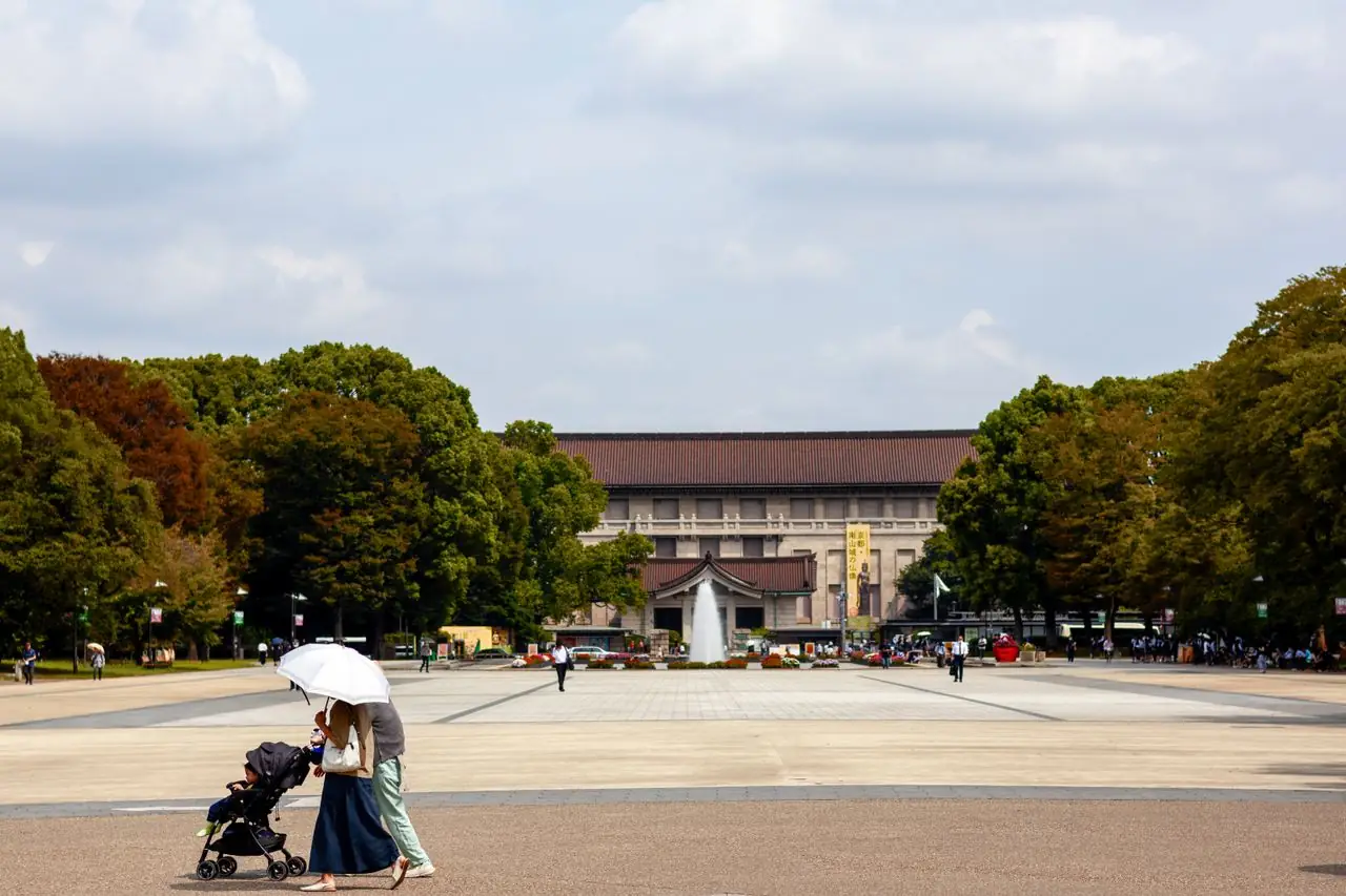 Parent with a stroller crossing Ueno Park in front of the Tokyo National Museum