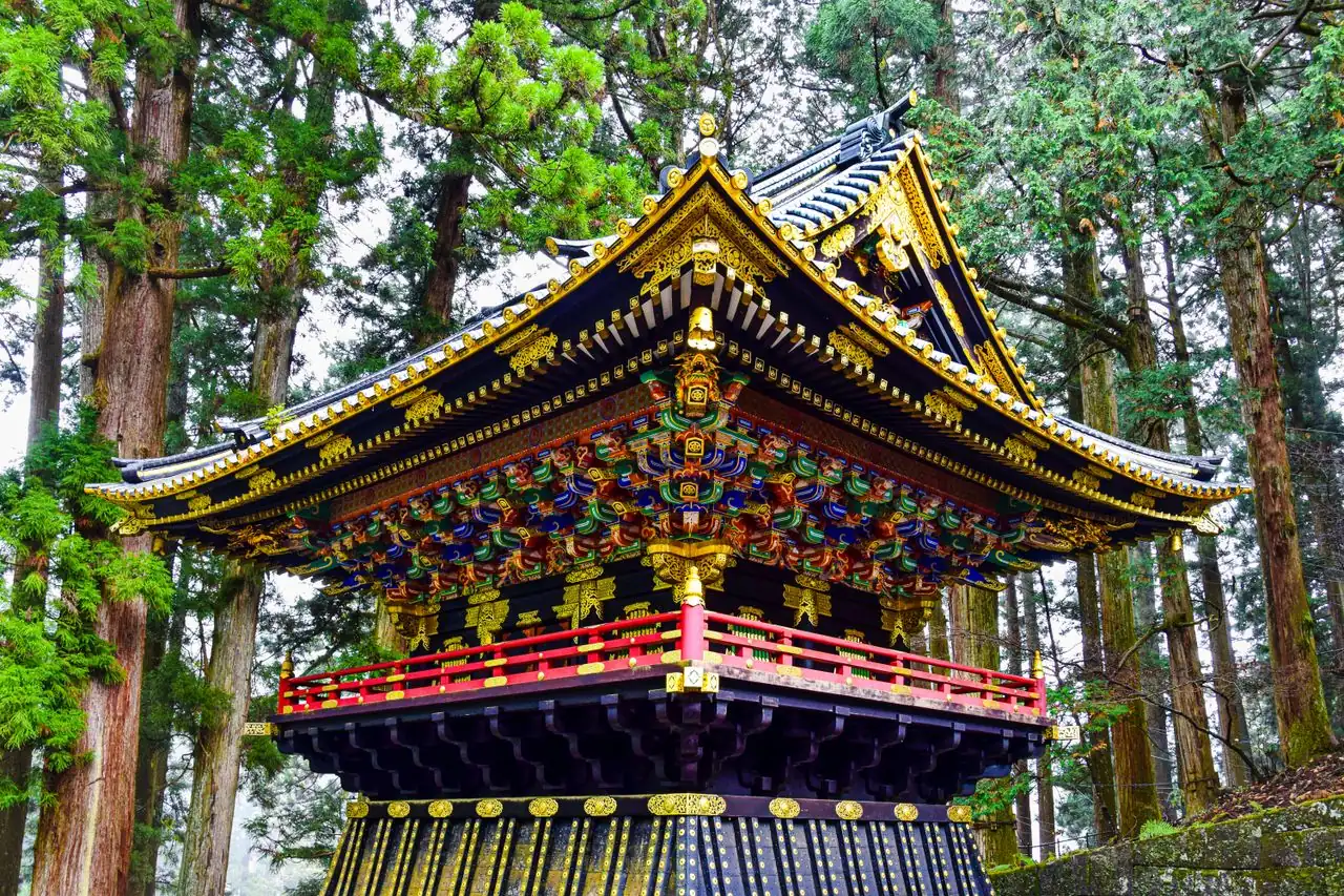 Lacquered and gilded tower among tall cedars at Taiyuin in Nikko