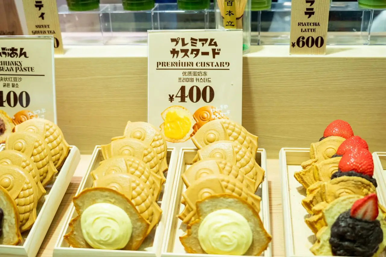 Fish-shaped taiyaki with red bean and custard fillings in a Japanese shop