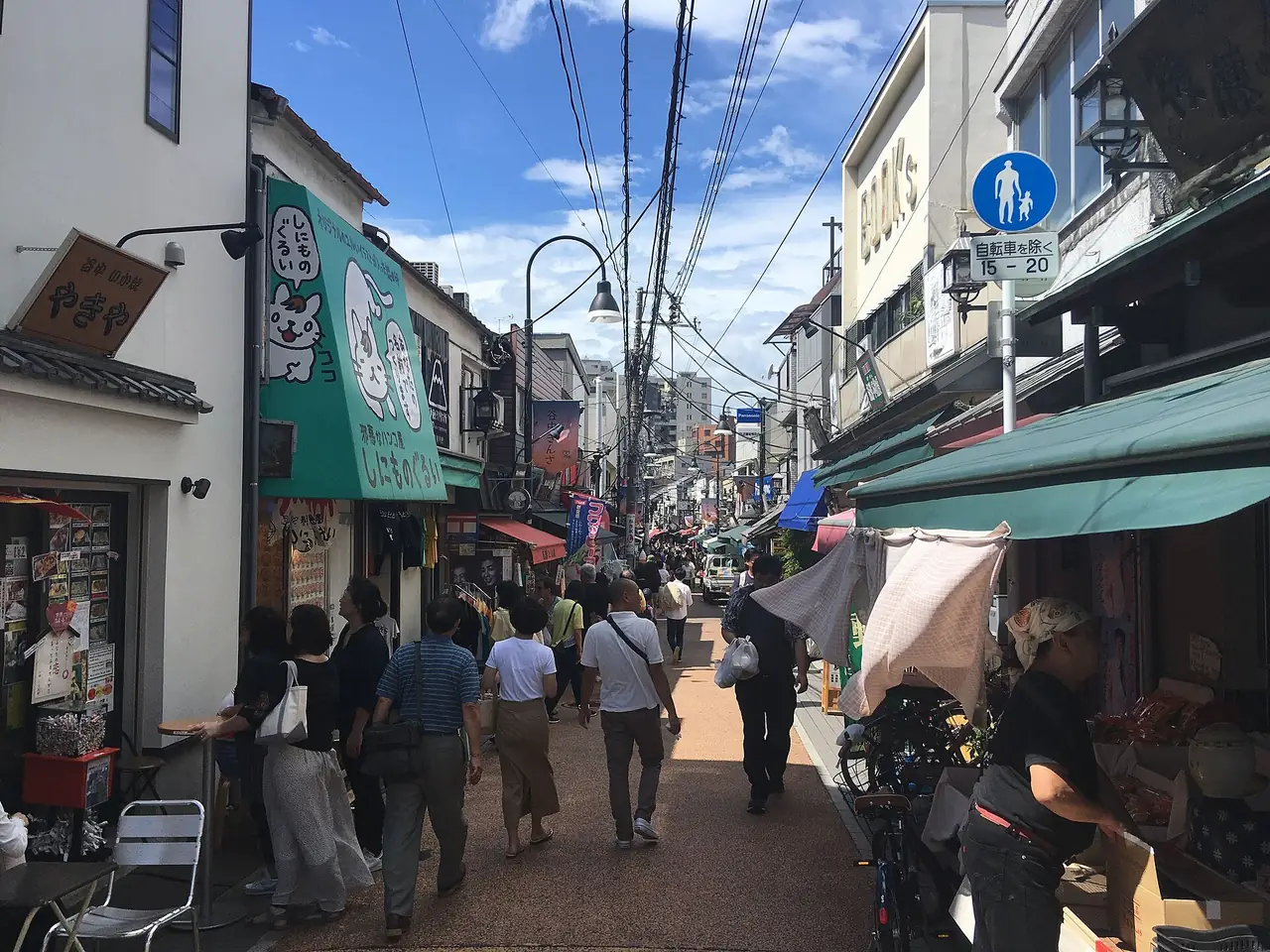 Shoppers walking past family-run shops on the Yanaka Ginza shopping street in Tokyo