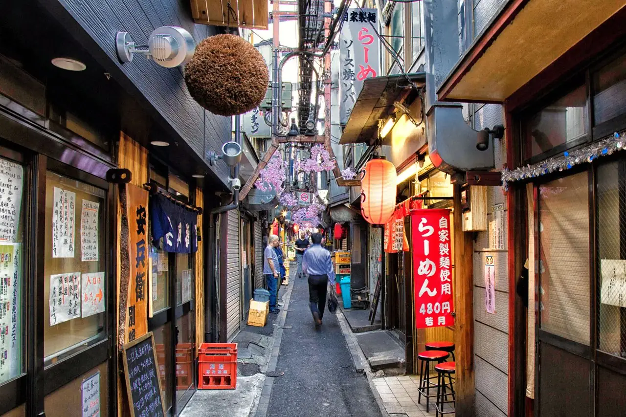Narrow Omoide Yokocho alley in Shinjuku lined with tiny eateries and a ramen shop