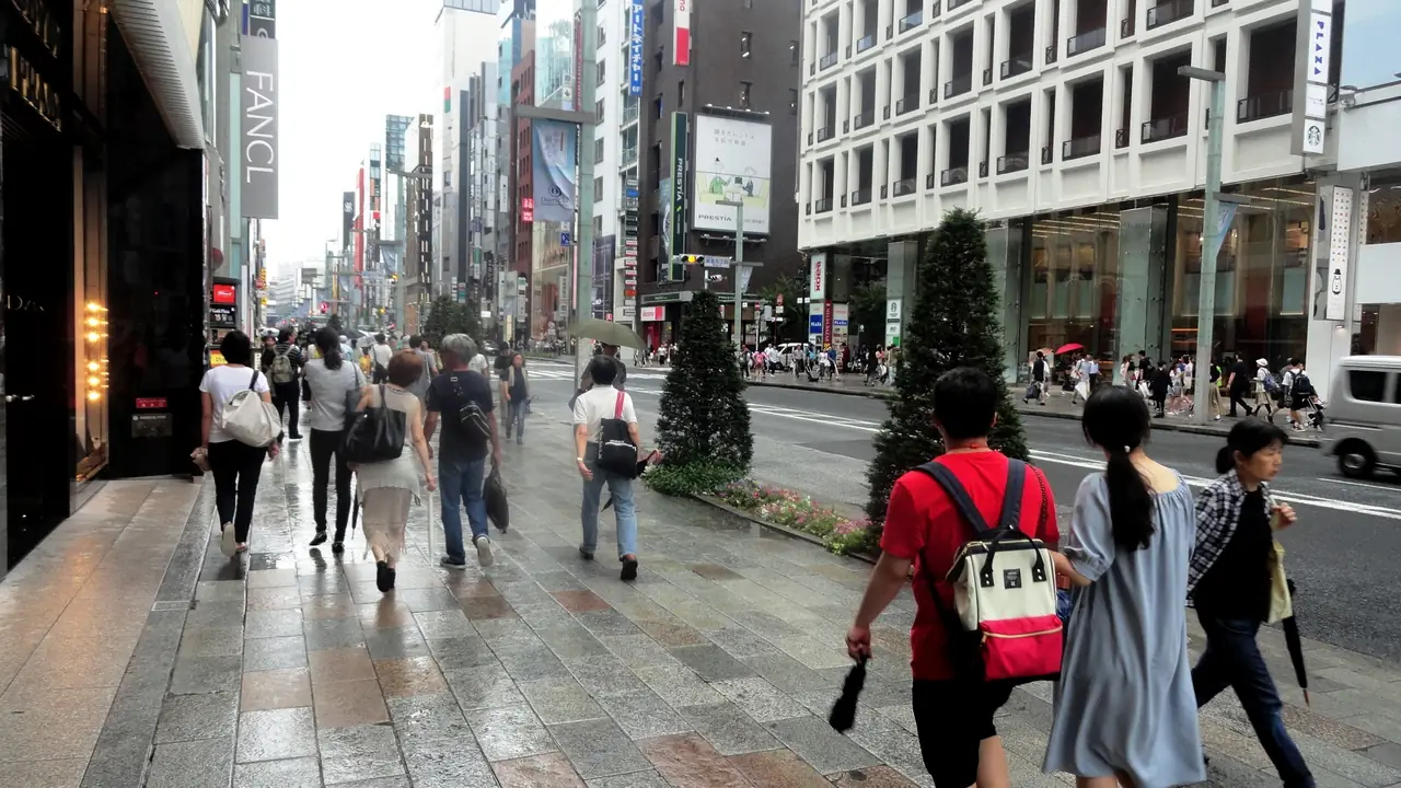Shoppers walking along Chuo-dori past department stores in Ginza