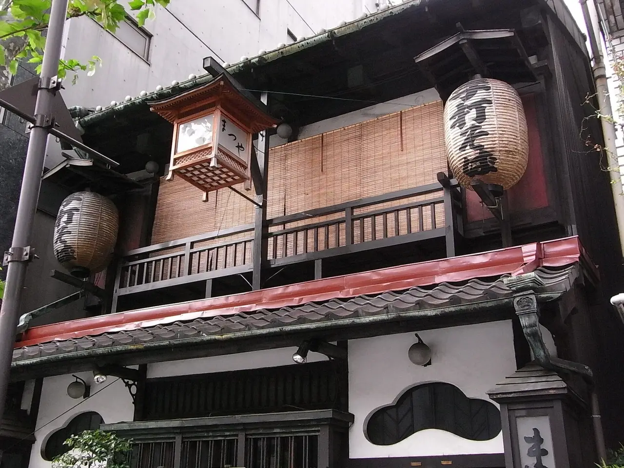 The traditional wooden facade and lanterns of Kanda Matsuya soba shop