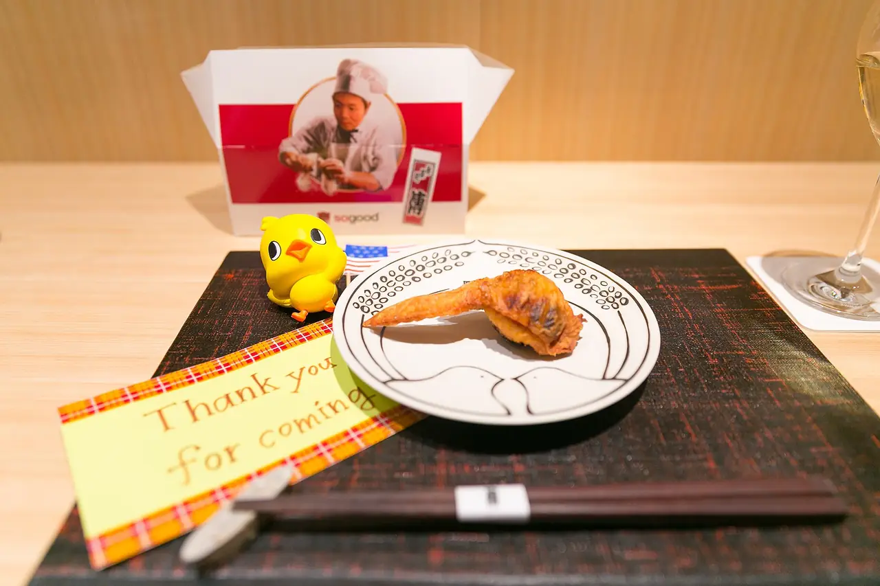 Den's playful stuffed fried chicken wing served in a branded box with a thank-you note