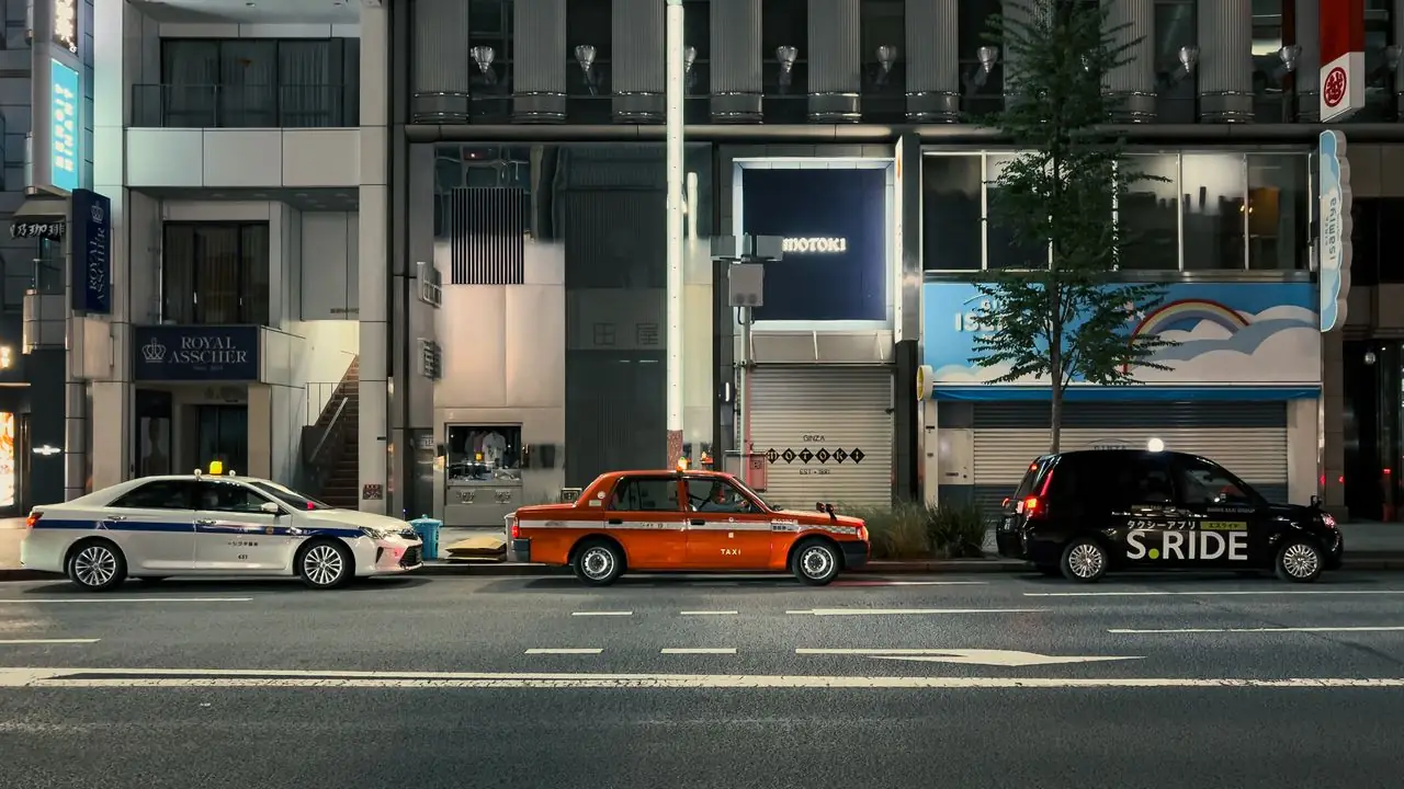 Tokyo taxis waiting at the curb on a street in Chuo City