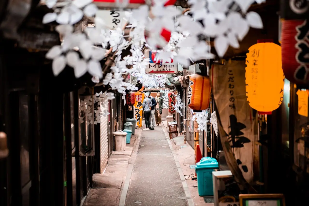 Paper lanterns and hanging decorations over a narrow Omoide Yokocho lane in Shinjuku