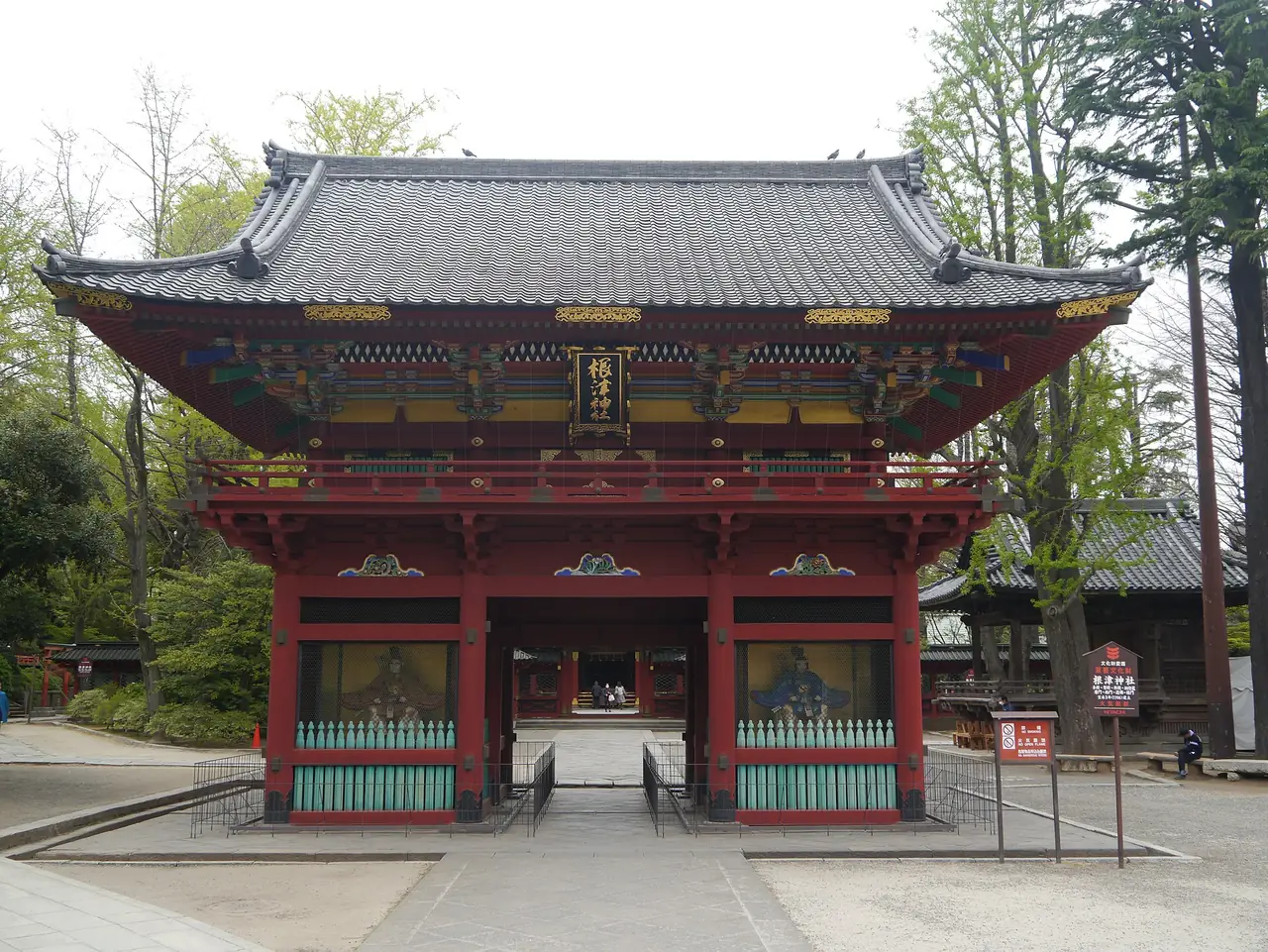 The two-story vermilion romon gate at Nezu Shrine with its lacquered beams
