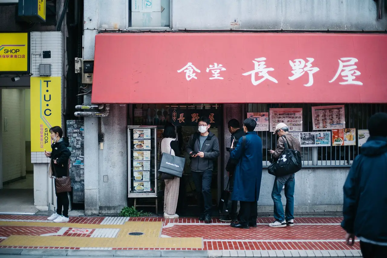People queuing outside Nagano-ya, a small diner in Shinjuku San-chome