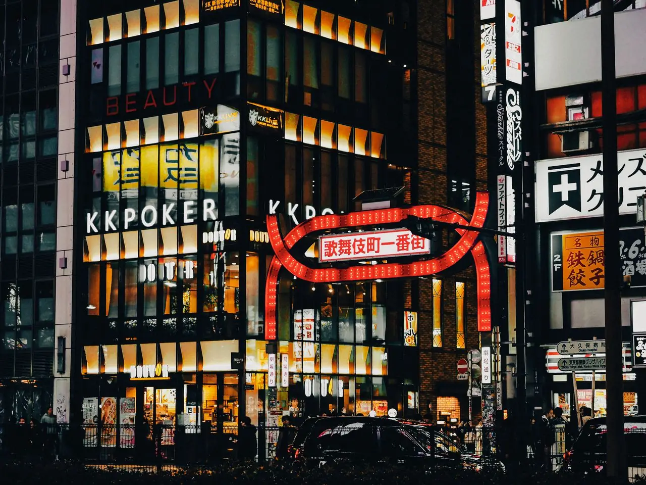 Kabukicho Ichibangai gate under lit building signs in Shinjuku at night