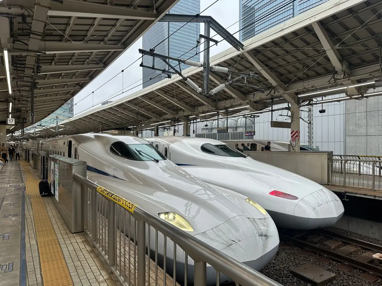 Two shinkansen bullet trains side by side at a Tokyo Station platform